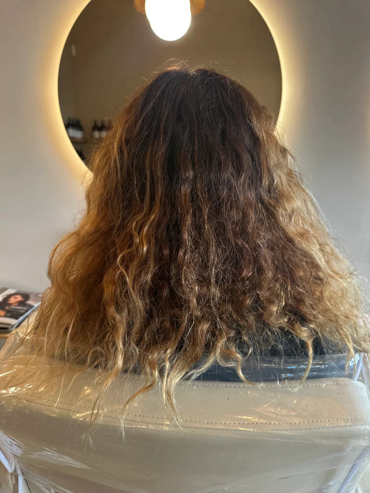 Avant une correction de couleur : racines foncées et longueurs chaudes sur cheveux bouclés à Nice